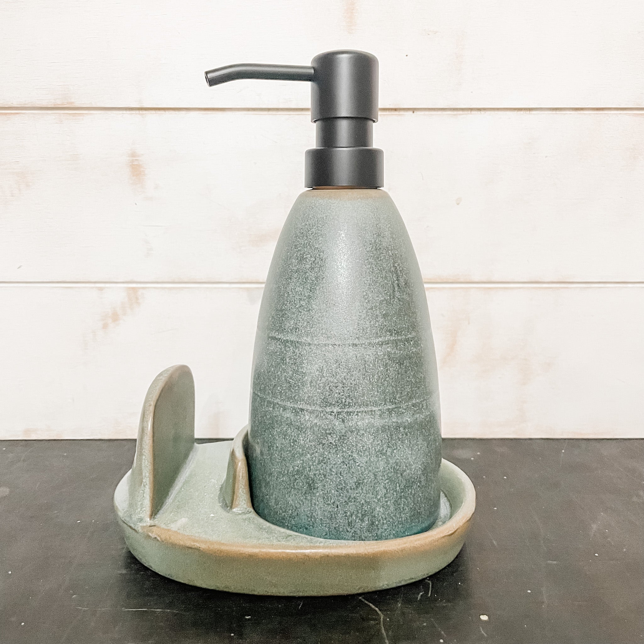 https://therusticbarnct.com/cdn/shop/products/matte-green-stoneware-soap-dispenser-with-loofah-and-loofah-holder-the-rustic-barn-ct.jpg?v=1671231666